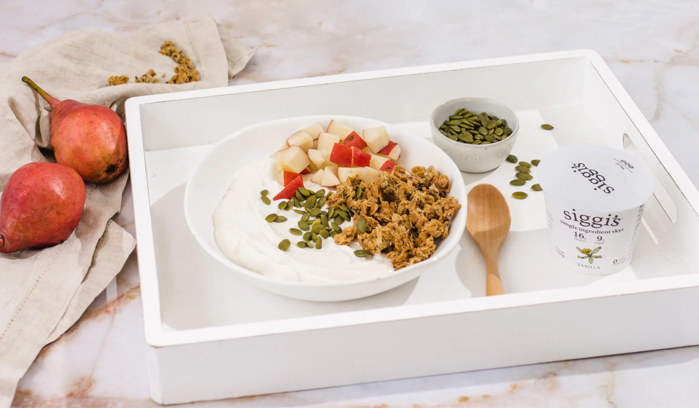vanilla yogurt parfait with granola, pears and pumpkin seeds