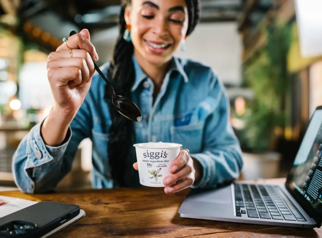 woman eating a vanilla siggi's skyr